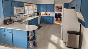 A modern kitchen with blue cabinets, a white countertop, and a built-in oven. - Spacious 1 story Home in Rapid City Historic District (Rapid City)