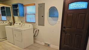 A laundry room with a washing machine, dryer, and a large mirror. - Spacious 1 story Home in Rapid City Historic District (Rapid City)