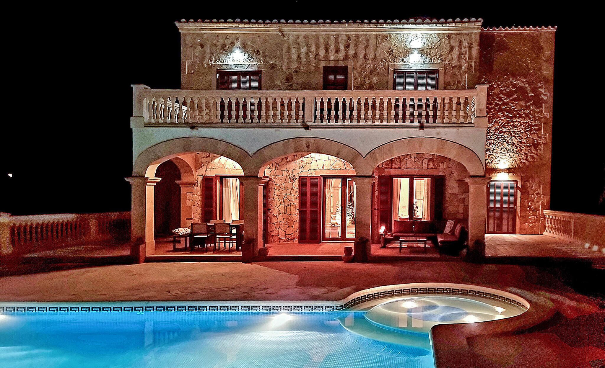 A two-story building with a pool in front.