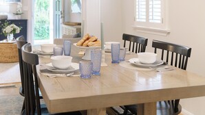 A dining table set with white bowls, blue glassware, and pastries. - Historic Annapolis Home! (Annapolis)