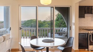 A modern kitchen with a granite countertop, a stove, and a black oven. - 2 BDR Ocean View Apt. in Pelada (Provincia de Guanacaste)