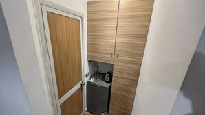 A compact kitchen with wooden cabinets, a small refrigerator, and a kettle. - NEAR THE PYRAMIDS INN 
5 minutes from the Great Pyramids of Giza & Sphinx!  (Giza)