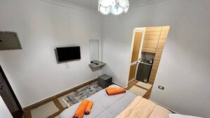 A compact hotel room with a bed, a TV, a small desk, and a kitchenette. - NEAR THE PYRAMIDS INN 
5 minutes from the Great Pyramids of Giza & Sphinx!  (Giza)
