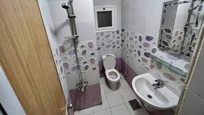 A bathroom with a shower, toilet, and sink. - NEAR THE PYRAMIDS INN 
5 minutes from the Great Pyramids of Giza & Sphinx!  (Giza)