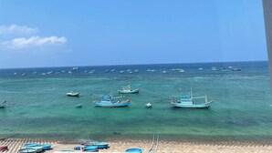A coastal scene with numerous boats anchored in clear blue waters. - Island Sunset Hotel (Phu Quy)