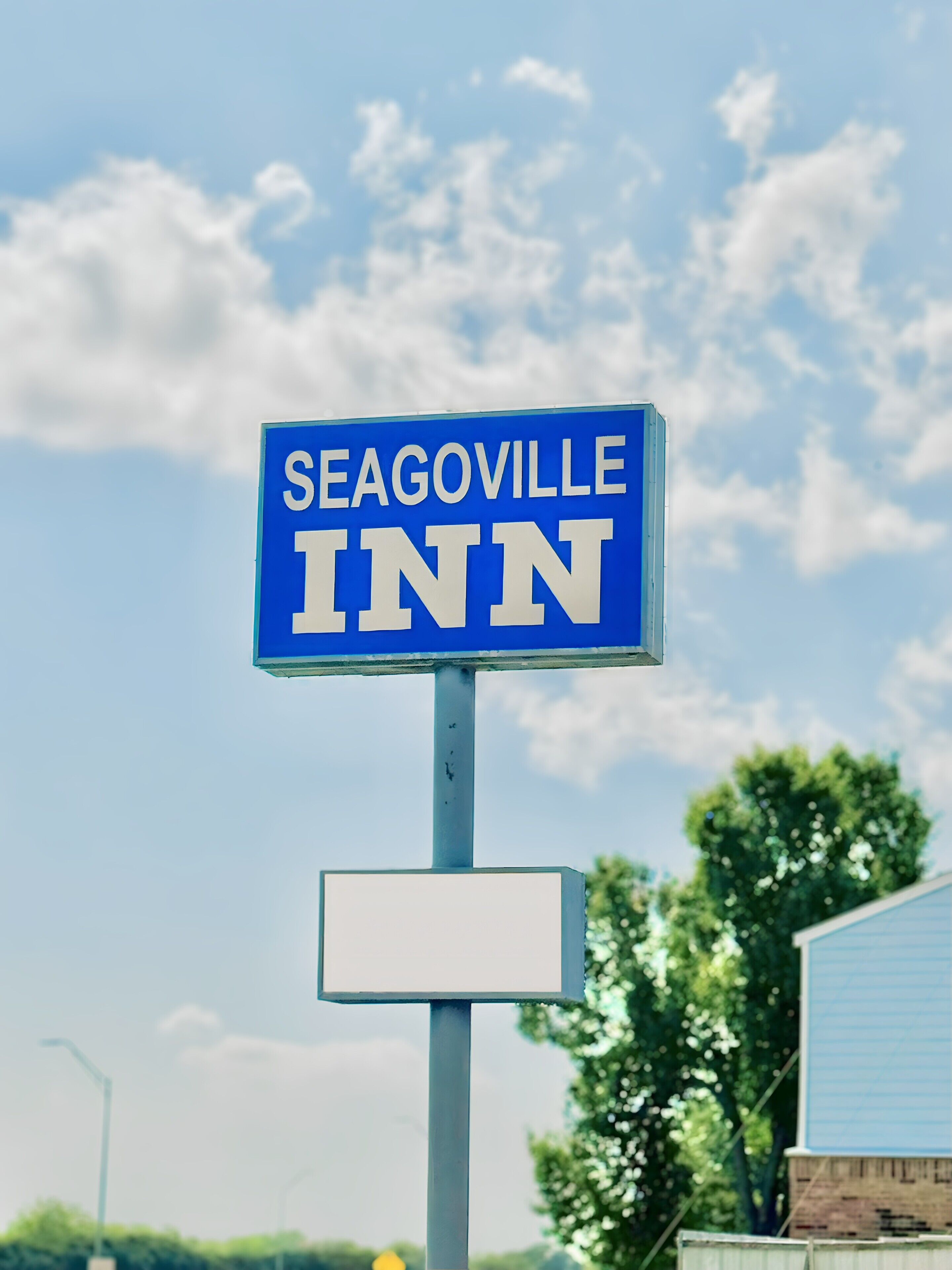 A blue sign with white text reading "SEAGOVILLE INN".
