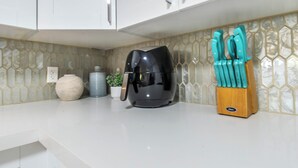 A kitchen counter with a coffee maker, a knife block, and a vase. - Gorgeous relaxing 2BD Near Ft. Myers Beach (Fort Myers)