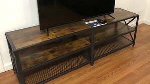 A flat-screen TV on a wooden TV stand with a mesh shelf. - 3,000 sf loft-style floor of a historic building, sleeps 8, NYC train 5-min walk (Elizabeth)