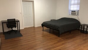 A bedroom with a bed, a desk, and a chair. - 3,000 sf loft-style floor of a historic building, sleeps 8, NYC train 5-min walk (Elizabeth)