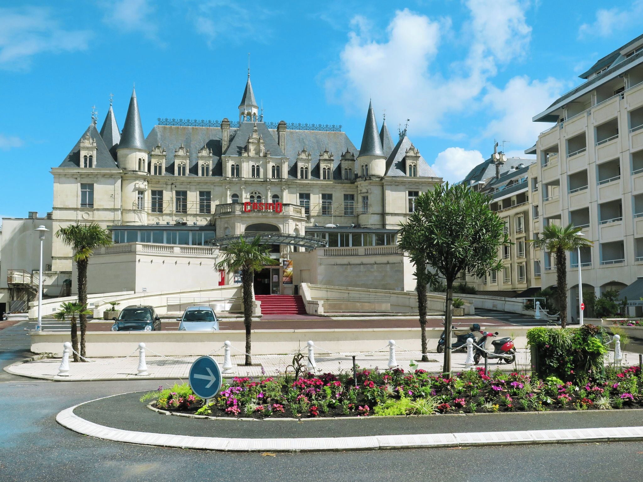 A grand hotel with a classic architectural style, featuring multiple towers and a prominent entrance.