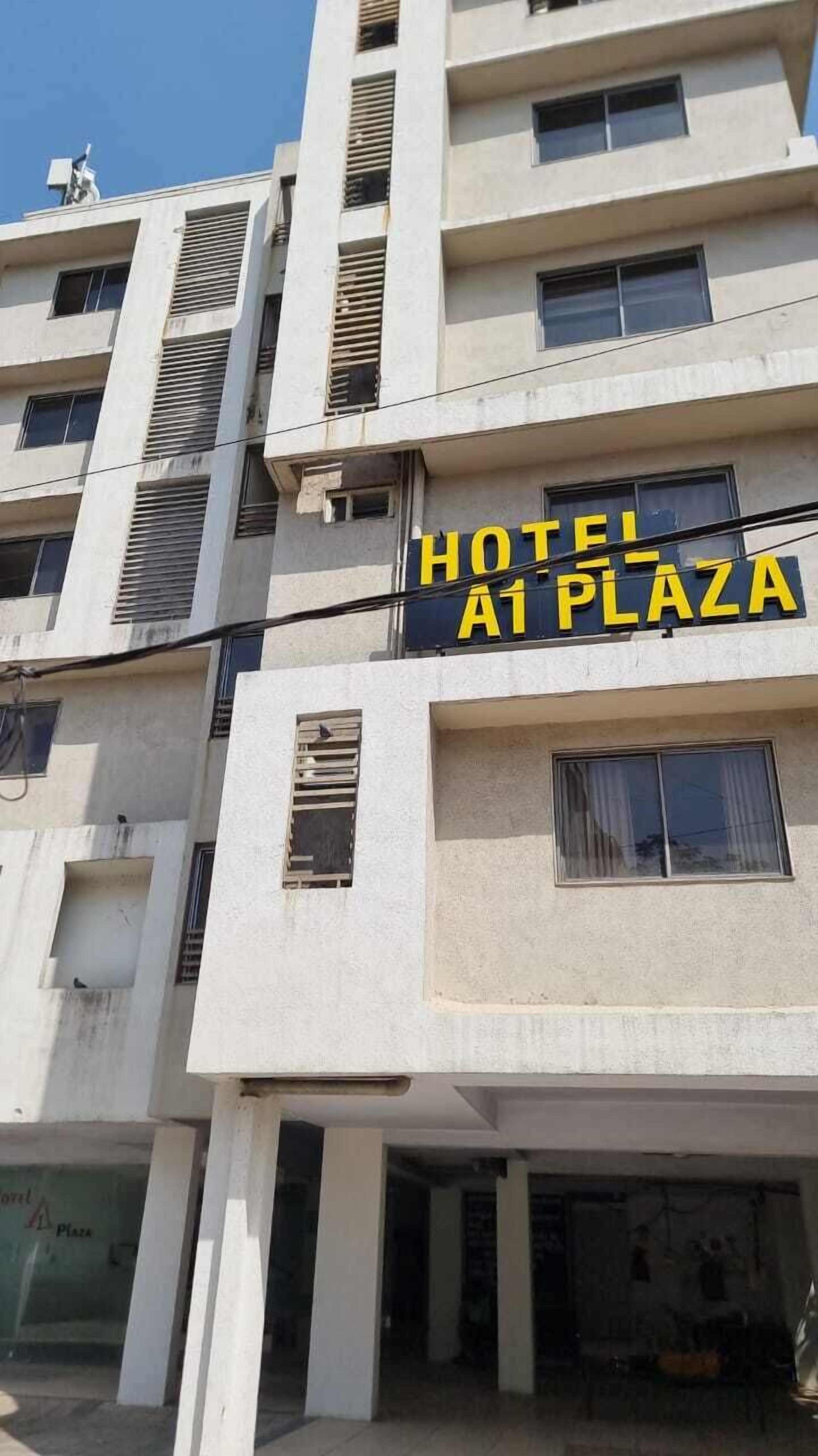 A multi-story building with a sign that reads "HOTEL A1 PLAZA".
