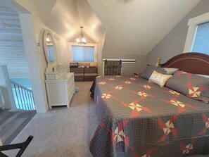 Une chambre à coucher avec un lit, une commode, un miroir et une fenêtre avec des stores.