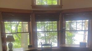 A bedroom with a large window, a wooden desk, a chair, and a bed. - Stunning cottage on Cayuga Lake, near wineries, waterfalls, Cornell University  (Interlaken)