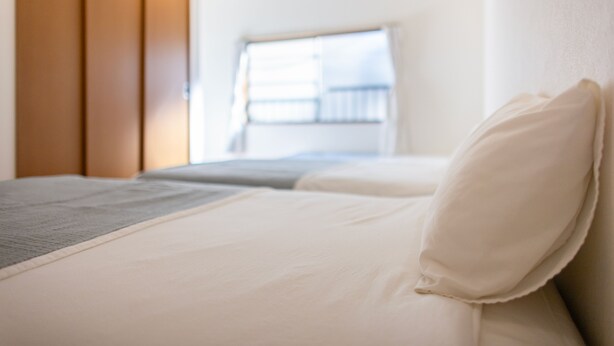 A hotel room with a bed, a window with a view, and a wardrobe. - UI HOUSE@Minamihorie (1 building rental / 2 stations 4 min. to Namba / walking distance to Kyocera Dome) (大阪市)
