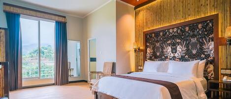 A spacious bedroom with a large bed, a view of the outdoors, and a decorative headboard.