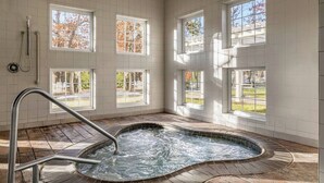 A spa room with a hot tub, large windows, and a shower area. - Unwind in Style: Marriott Fairway Villas (Galloway)