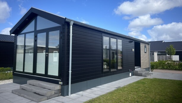 A modern house with large windows, a flat roof, and a small front porch. - De Zeeparel by Interhome (Scherpenisse)