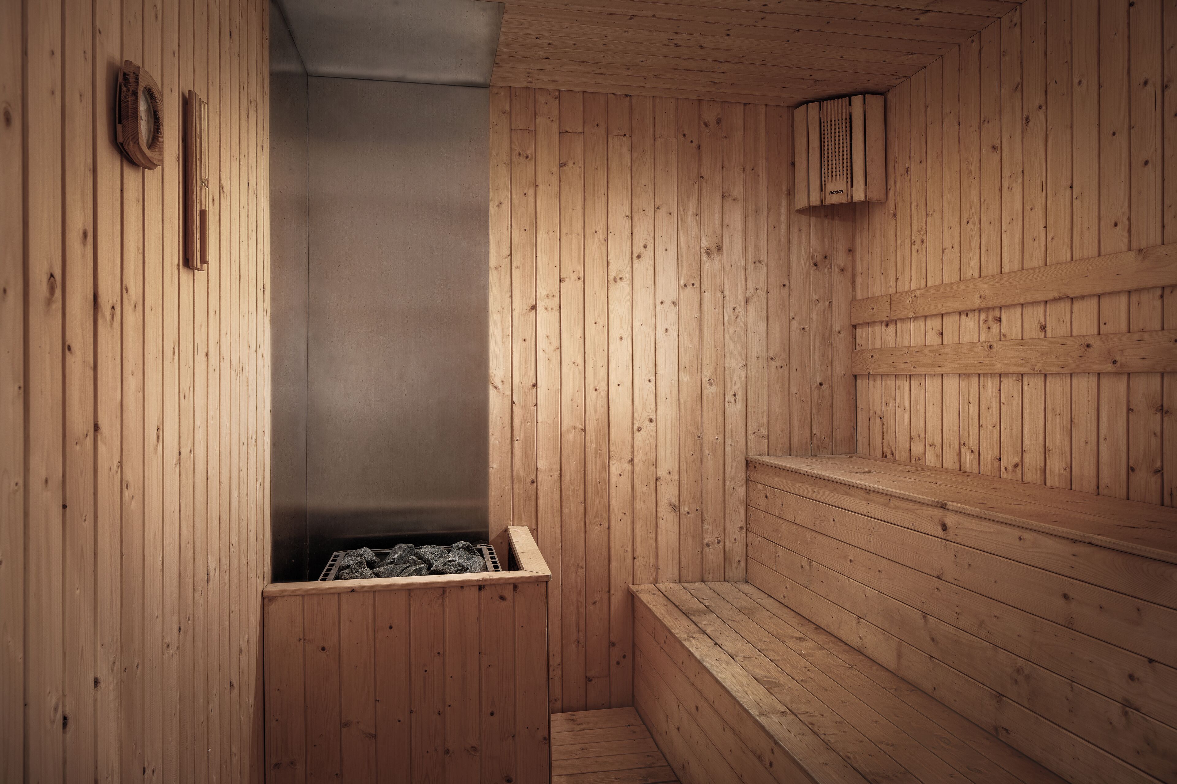 A wooden sauna with benches and a steam room.