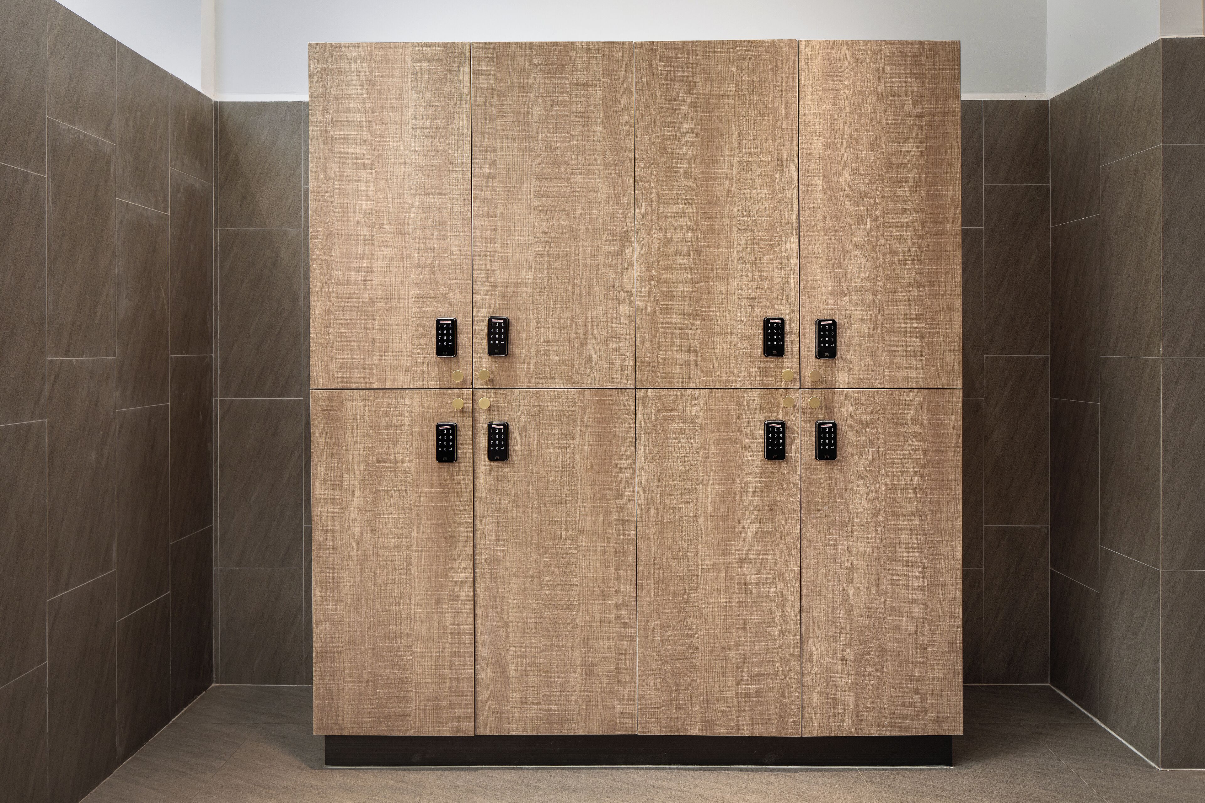 A modern wardrobe with four doors, each with a black electronic lock.