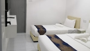 A hotel room with two beds, a ceiling fan, an air conditioning unit, and a TV mounted on the wall. - SKYN SMART HOME (Ipoh)