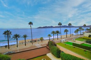 Stroll along the scenic promenade with breathtaking views of the sea and distant mountains.