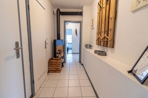 Stylish hallway with a coat rack, picture frame, and shelf.
