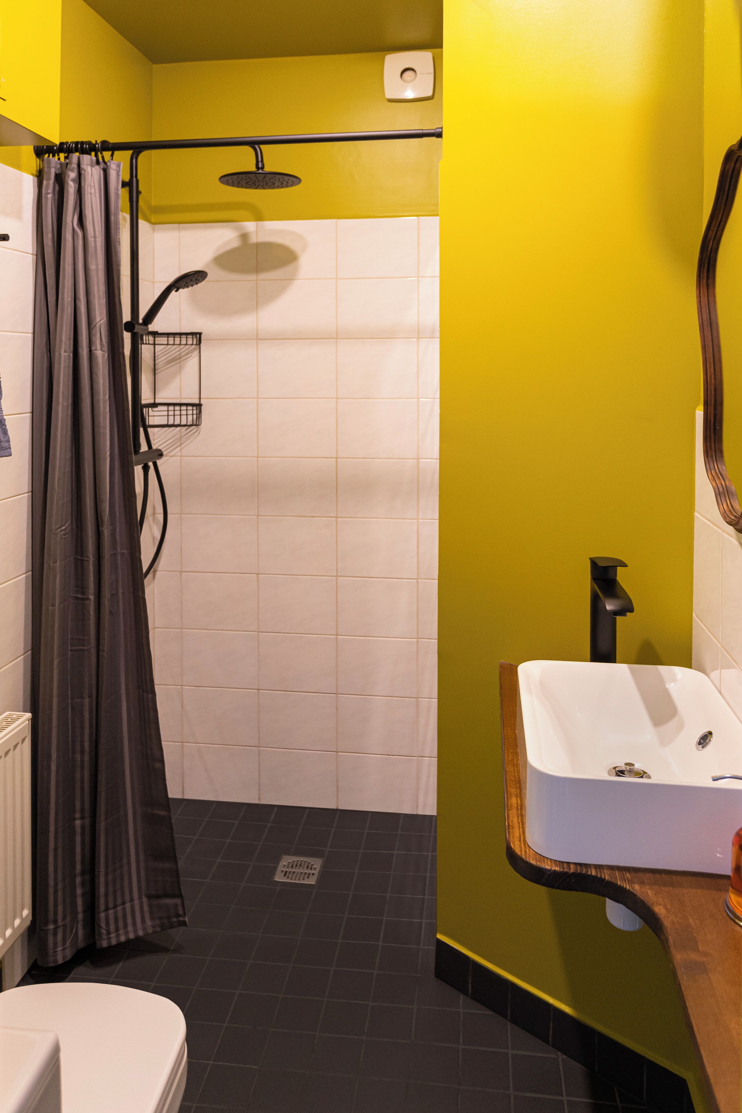 A bathroom with a shower, toilet, and sink.