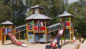 A playground with multiple slides and climbing structures.