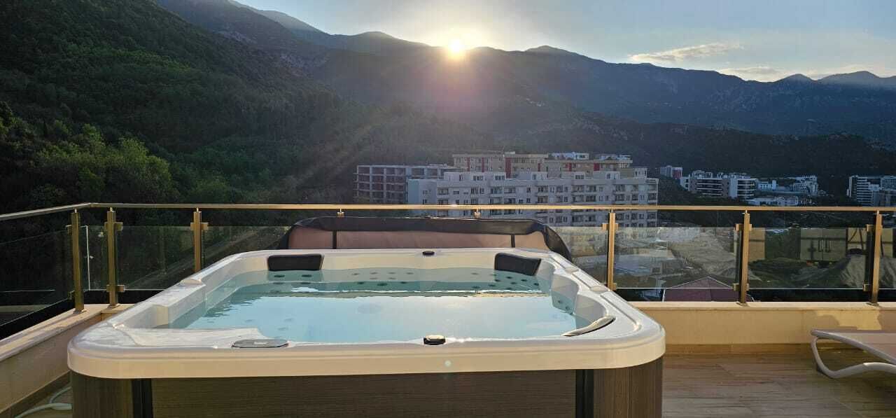 A hot tub on a balcony with a mountain view.