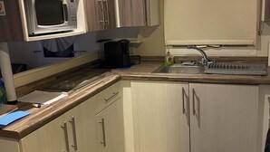 A compact kitchen with a microwave, coffee maker, and sink. - Immaculate 3-bed Caravan 10mins From Gt Yarmouth (Great Yarmouth)