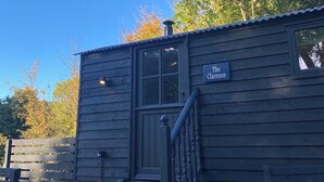 A small wooden cabin with a sign reading "The Clancee." - Extremely remote elegant hut set with valley views immersed in nature.  (Sittingbourne)