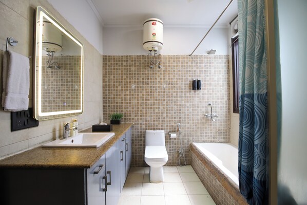 A bathroom with a sink, toilet, bathtub, and a shower.