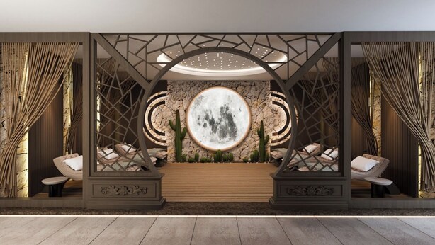 A modern interior with a central seating area, a circular wall feature, and a geometric ceiling design. - Renex Hotels (Antalya)