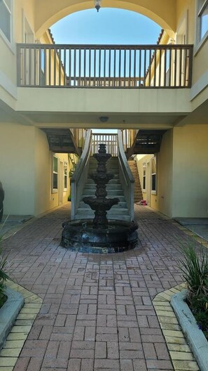 Stroll through the serene courtyard, surrounded by a central fountain and lush greenery.