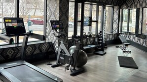 A gym with exercise equipment, large windows, and patterned walls. - Cozy 2BR Apt in Arlington, VA. Minutes from  Washington D.C. (Arlington)