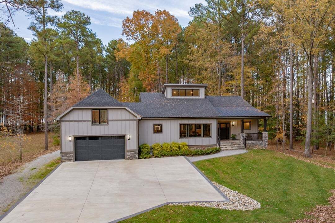 A two-story house with a garage, a front porch, and a driveway.