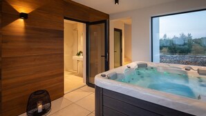 A modern bathroom with a hot tub, wooden paneling, and a view of the outdoors. - Luxury villa with swimming pool and sauna near Pula. (Vodnjan)