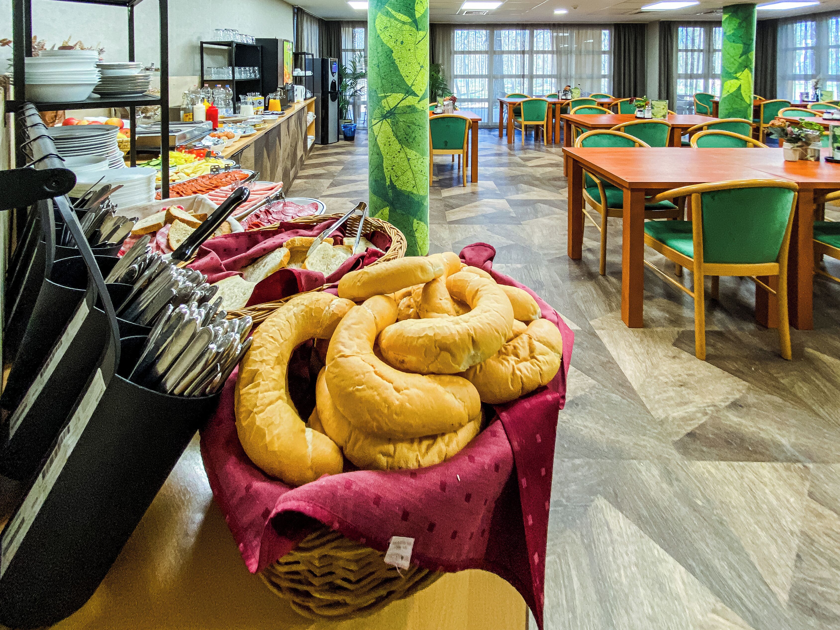 A buffet area with various food items and dining tables.