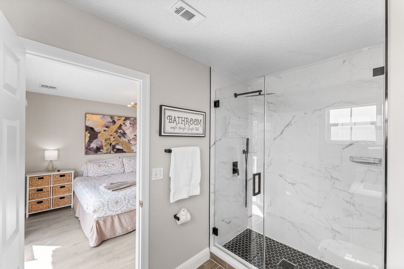 A bathroom with a glass shower enclosure and a sign that reads "BATHROOM with big glass shower tub."