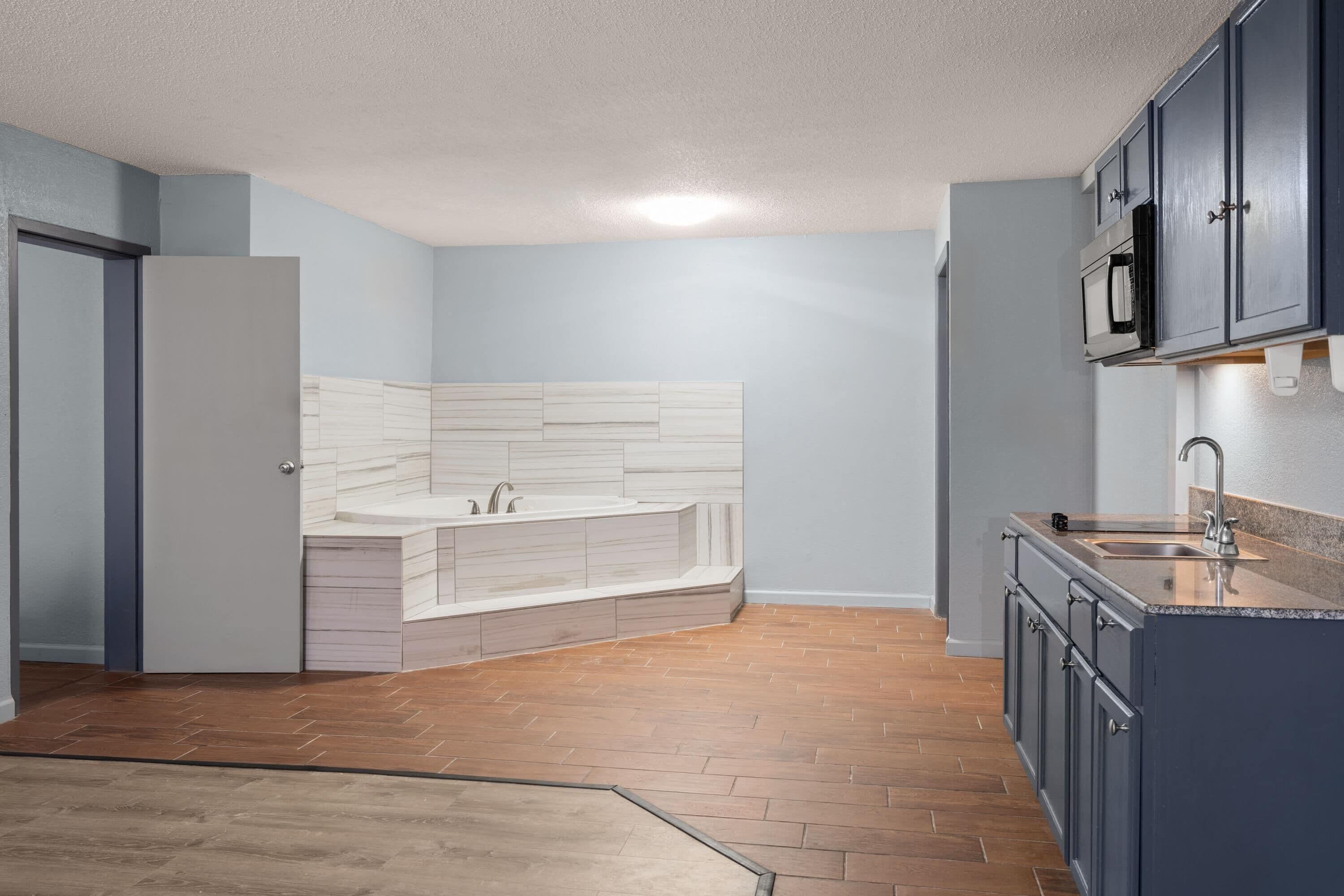 A kitchen with a built-in island, a microwave, and a sink.