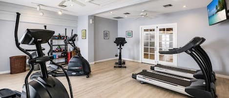 A home gym with treadmills, an elliptical, and a stationary bike.