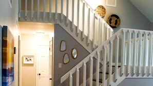 A staircase with white railings leading to an upper level.