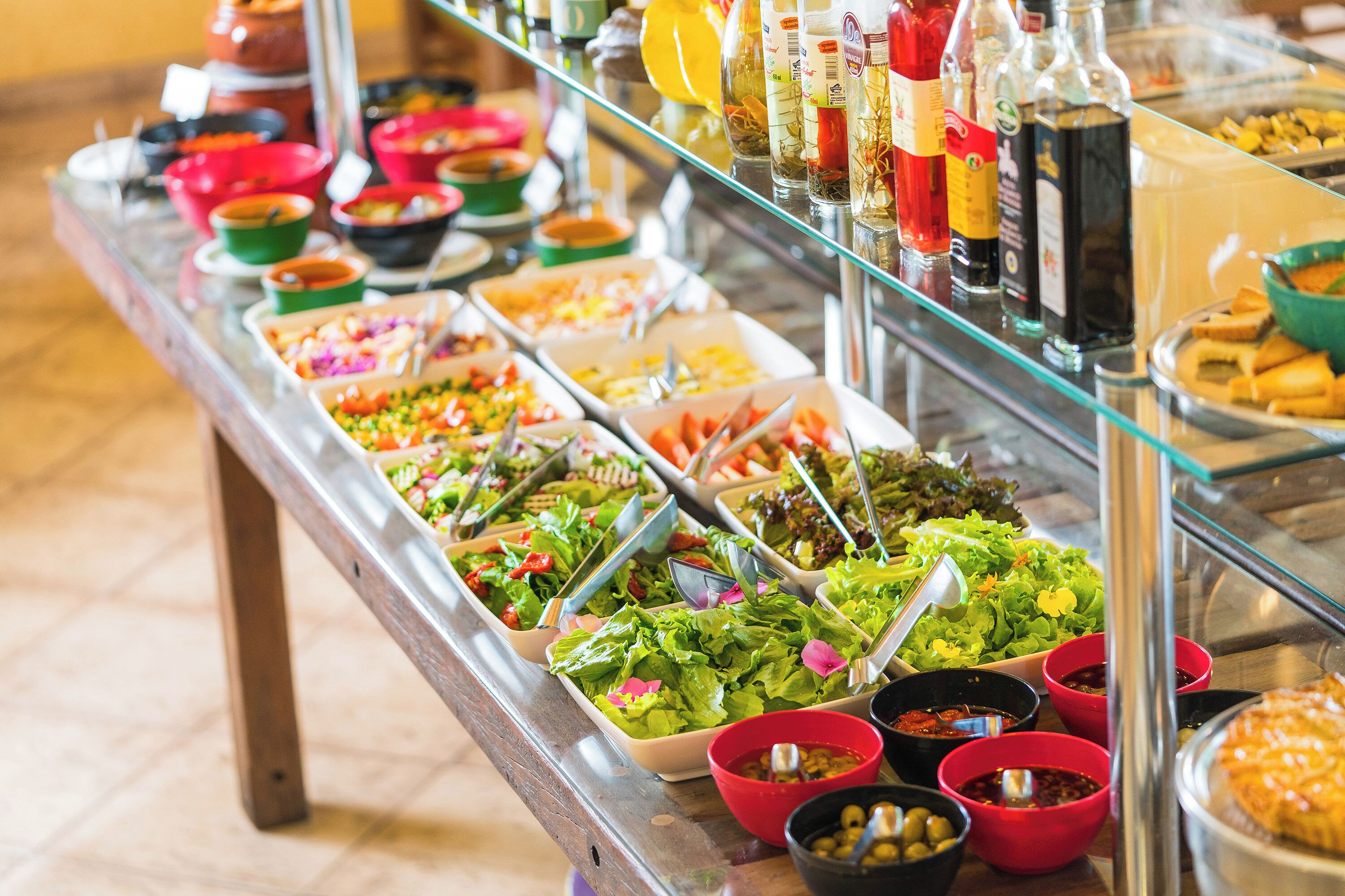 A buffet with various food items and condiments.