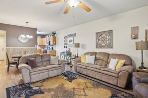 A living room with two sofas, a coffee table, a rug, and a ceiling fan. - Two bedroom, two bathroom with walk in Shower condo located just off the parkway (Pigeon Forge)