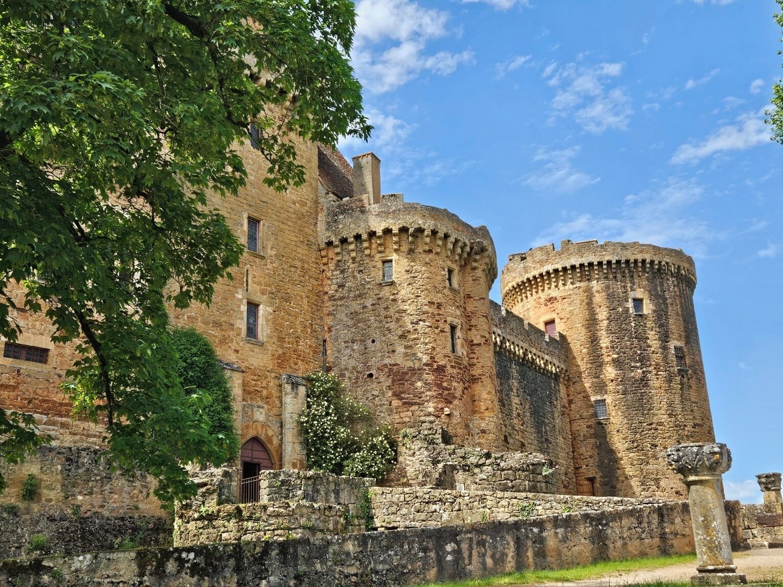 A historic stone castle with multiple towers and a fortified wall.