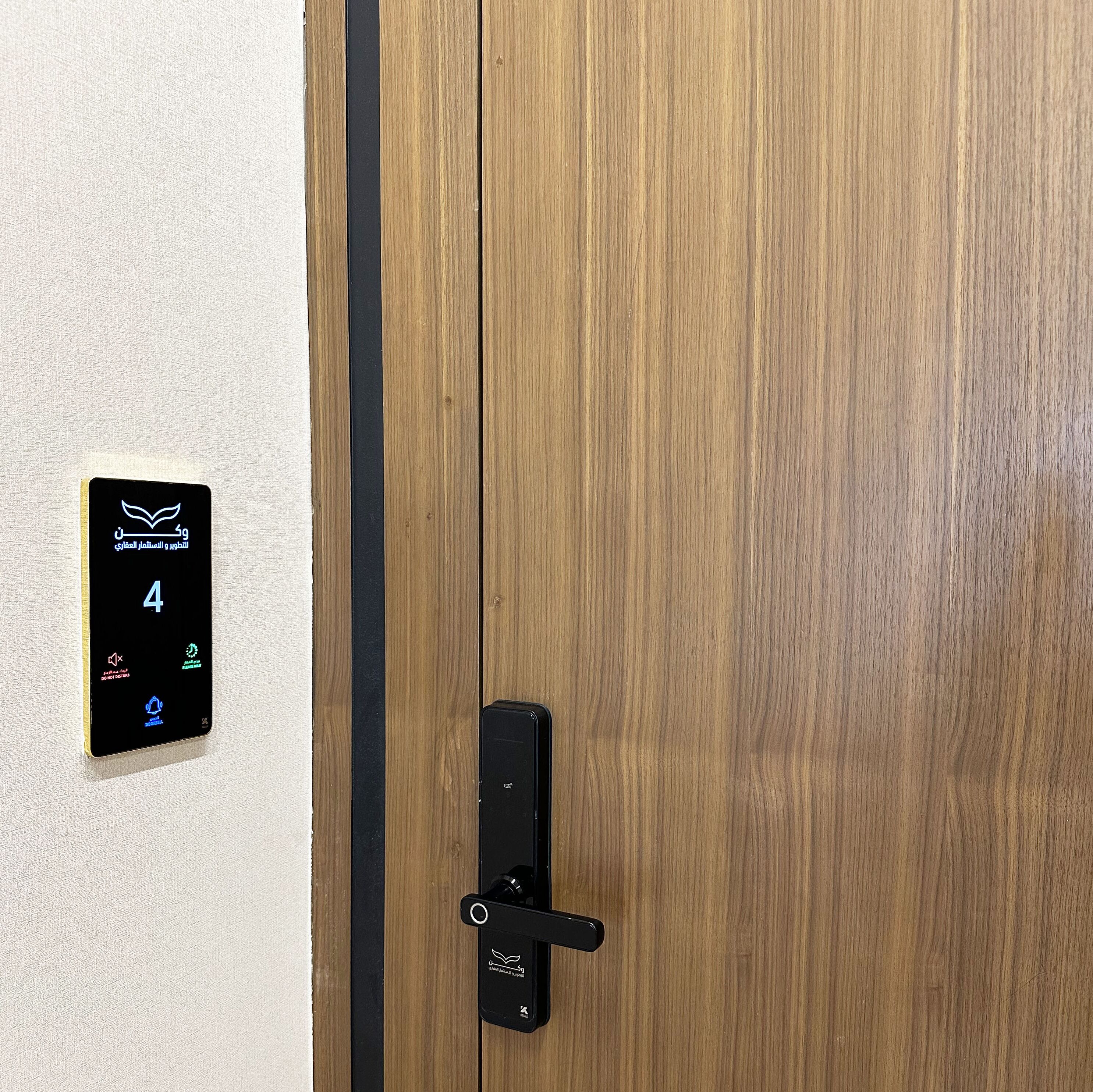 A wooden door with a digital lock and a control panel displaying a number 4.