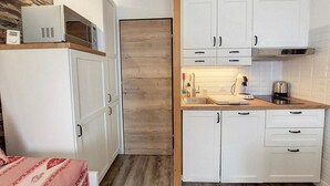 A compact kitchen with white cabinets, a microwave, and a sink. - 200m from ski slopes, 1st floor, balcony, tv, ski locker, 26m², La Rosière (La Rosière Montvalezan)
