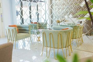 Relax in a clean and inviting space with a seating area featuring a sofa and armchairs.
