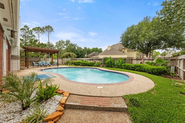 Dive into your private oasis with a large pool and lounge seating.