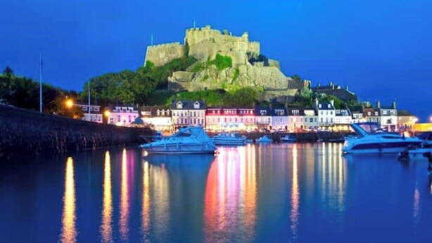 A historic castle on a hill overlooking a harbor with boats docked in the water. - Ultimate Gorey Retreat (jersey)